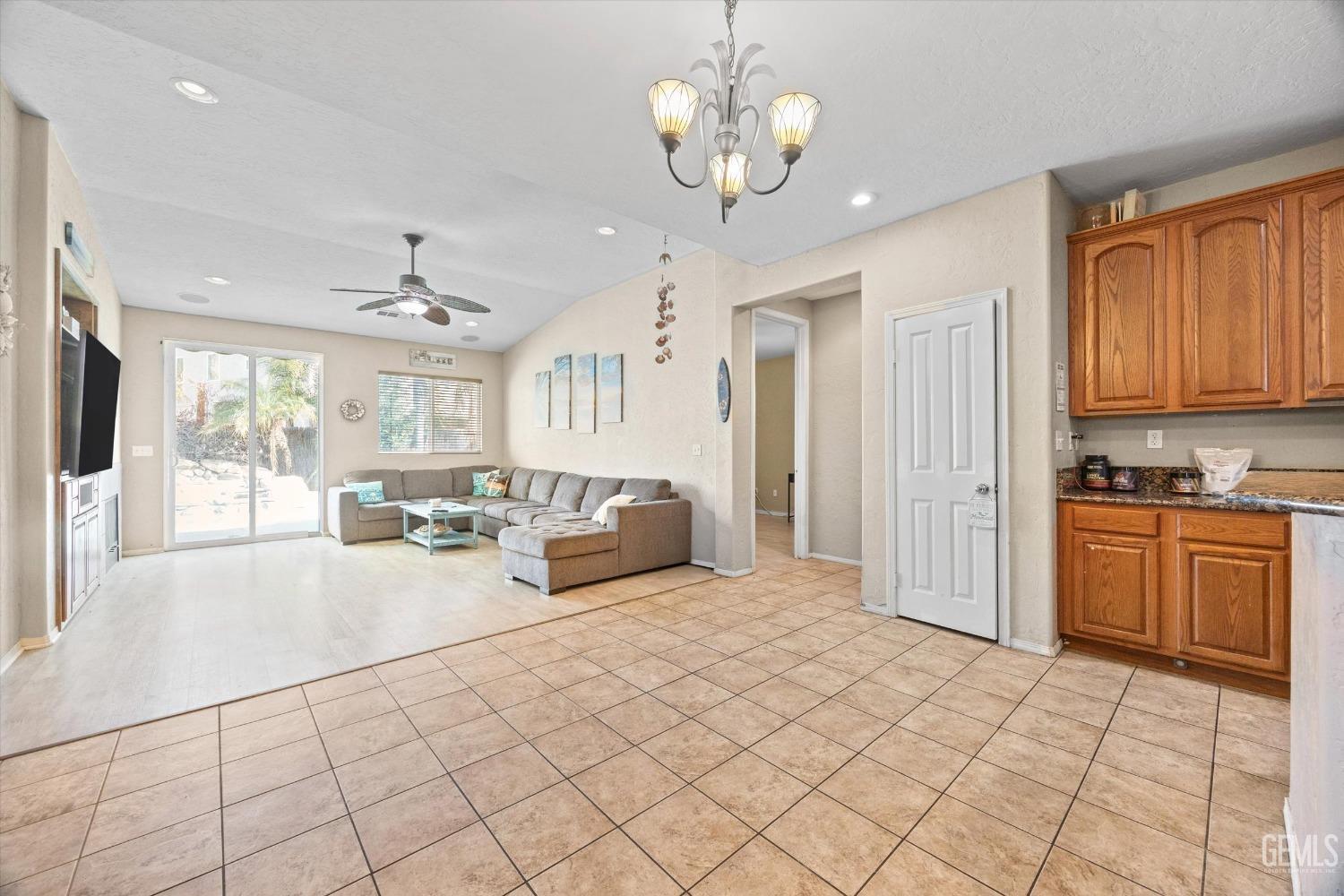 Undisclosed Address Bakersfield, CA 93313 - Photo 6 of 24 a large room with chandelier fan and windows