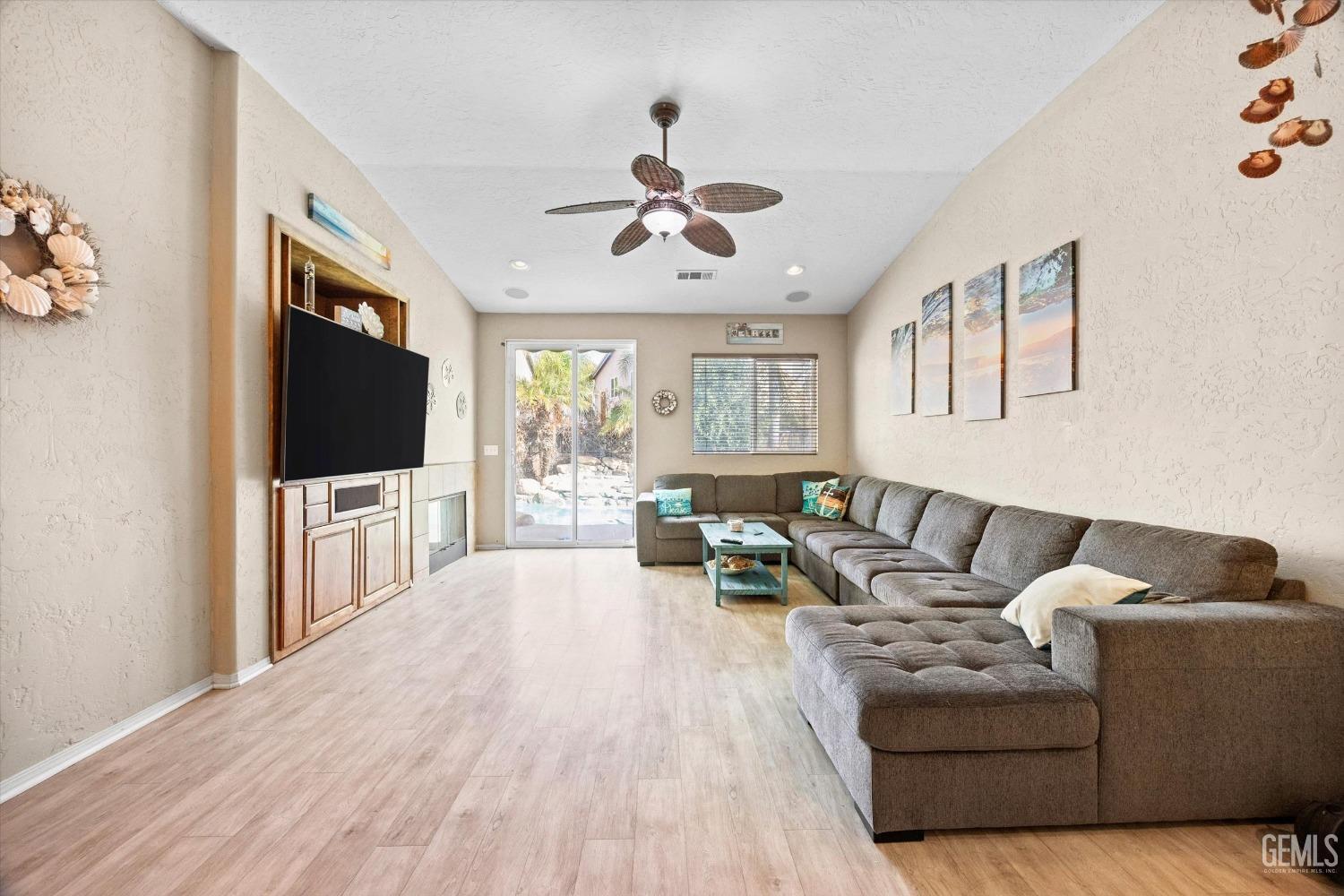 Undisclosed Address Bakersfield, CA 93313 - Photo 8 of 24 a living room with furniture and a flat screen tv