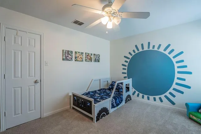 a room with a bed and a chandelier