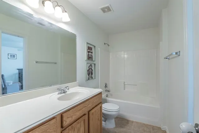 a bathroom with a sink toilet a mirror and shower