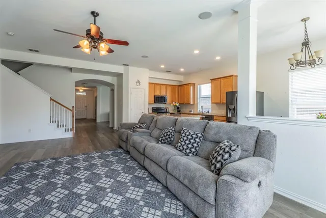 a living room with furniture and a chandelier