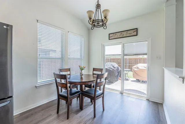 a view of a dining room with furniture wooden floor and a chandelier