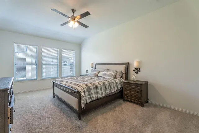 a spacious bedroom with a bed and a large window