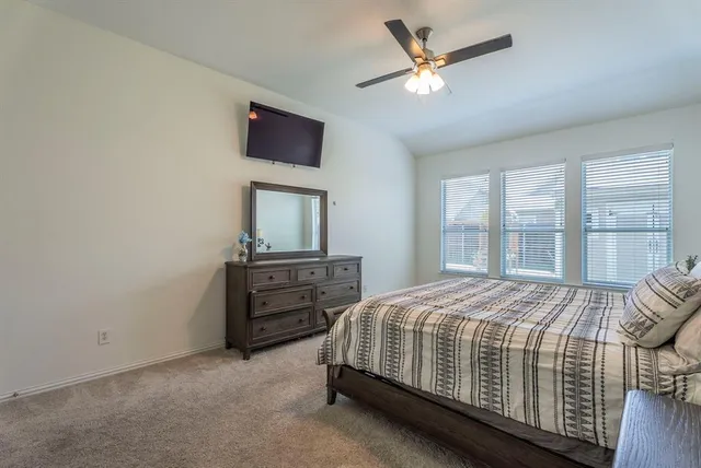 a bedroom with a bed table and a window