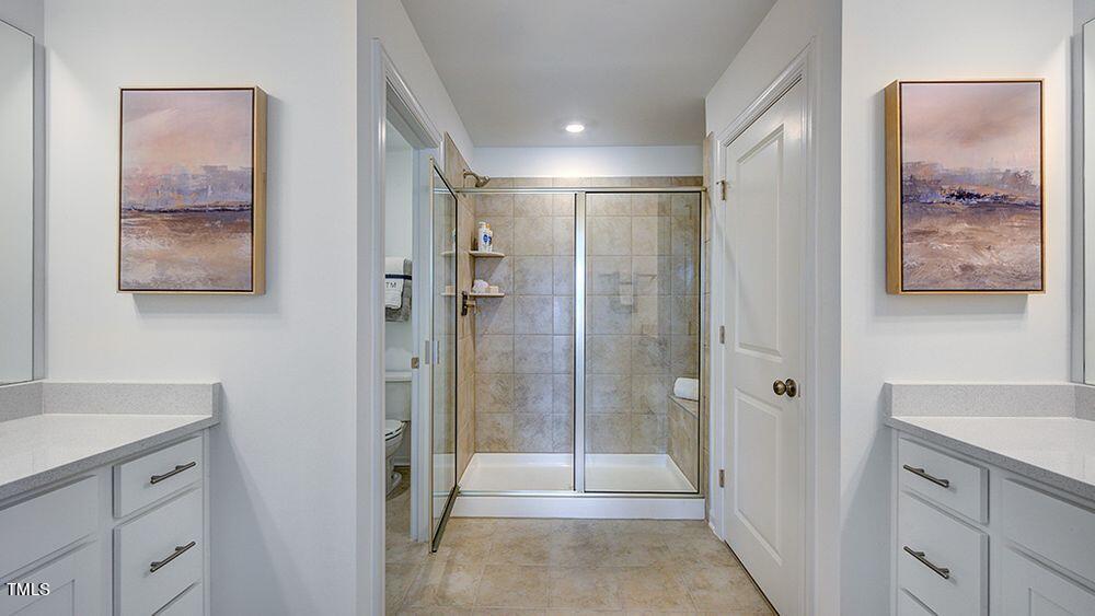 281 Hank Way Angier, NC 27501 - Photo 10 of 15 a bathroom with a shower sink and mirror
