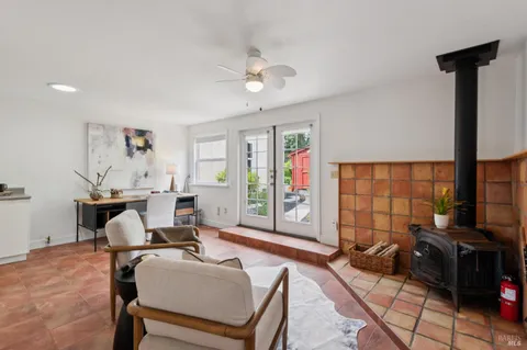 a living room with furniture a table and a large window