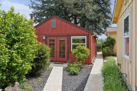 a front view of a house with outdoor seating and plants