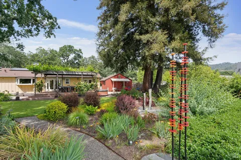 a patio with water view fountain with wooden floor and fence