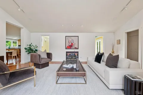 a living room with fireplace furniture and a flat screen tv