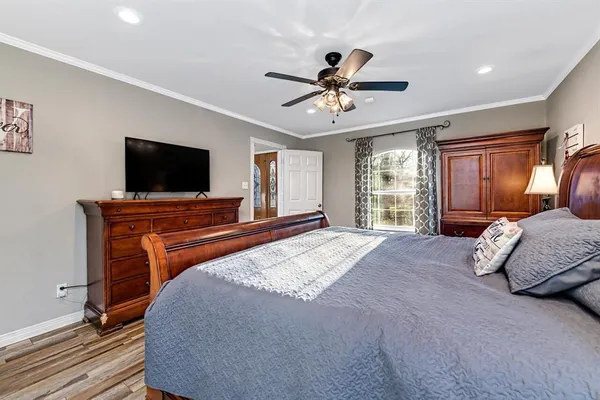 a bedroom with a bed and a flat screen tv
