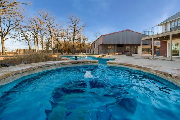 a view of pool with outdoor seating