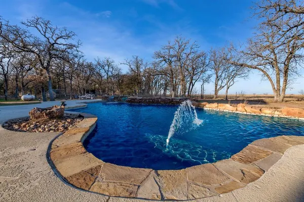 a view of swimming pool with seating space