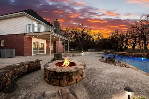 a view of a house with a yard patio and sitting area