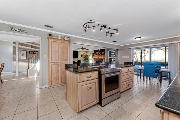 a kitchen with stainless steel appliances granite countertop a stove and cabinets