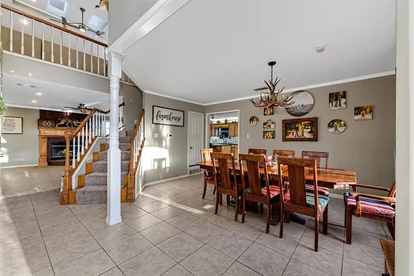 a view of a dining room with furniture and chandelier