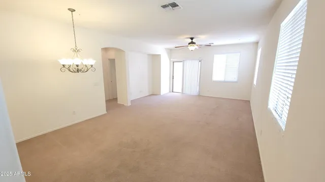 a view of a room with windows and chandelier