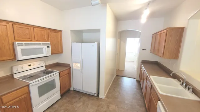 a kitchen with stainless steel appliances a stove a microwave a sink and a refrigerator