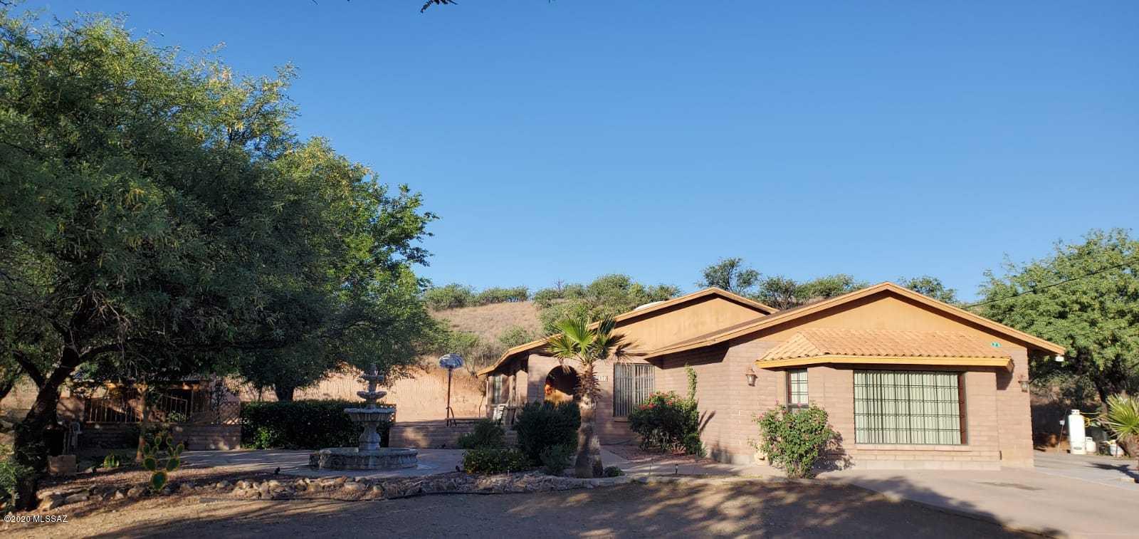 173 Nabo Court Rio Rico, AZ 85648 - Photo 1 of 26 a front view of a house with a yard