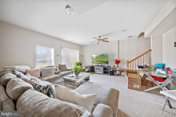 a living room with furniture fireplace and a window