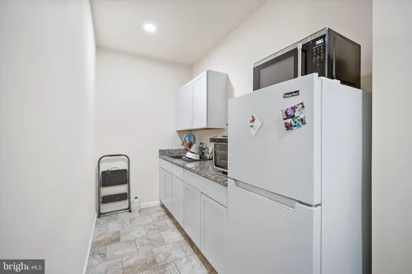 a white refrigerator freezer sitting inside of a kitchen