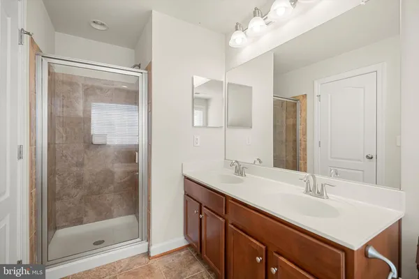a bathroom with a sink double vanity and a mirror