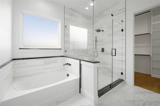 a bathroom with a granite countertop sink two mirror and a shower