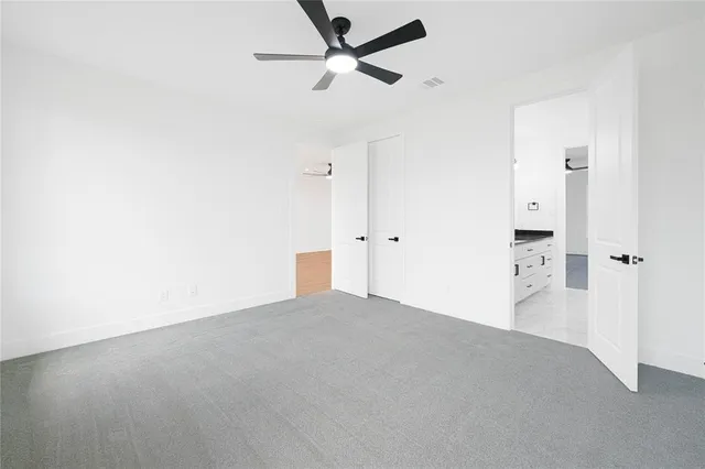 a bedroom with bed and a chandelier