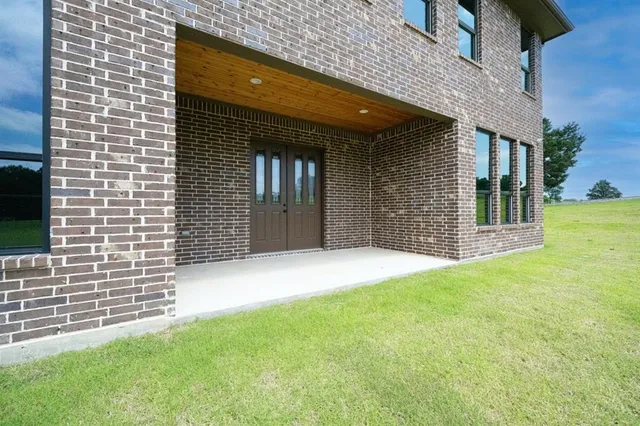 a view of a patio with table and chairs and potted plants