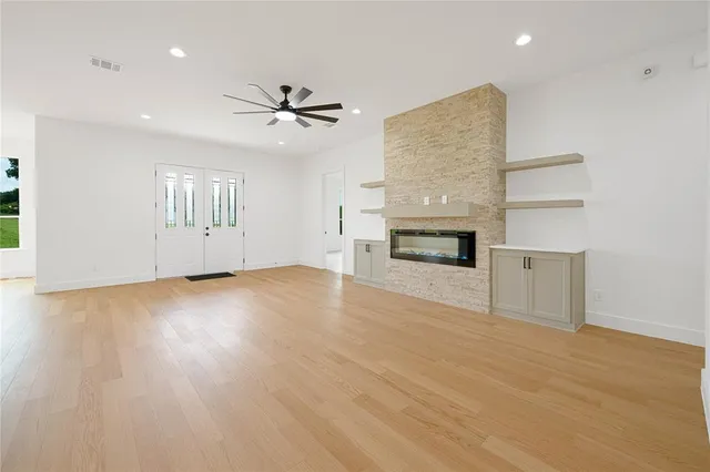 a living room with furniture a table and a fireplace