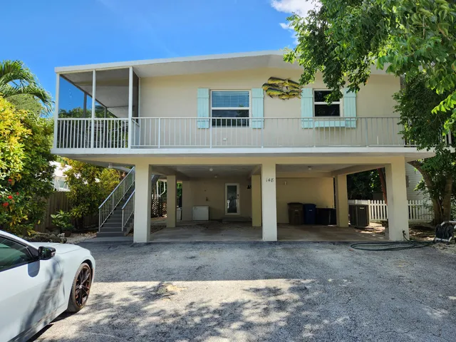 a view of a house with a yard and plants