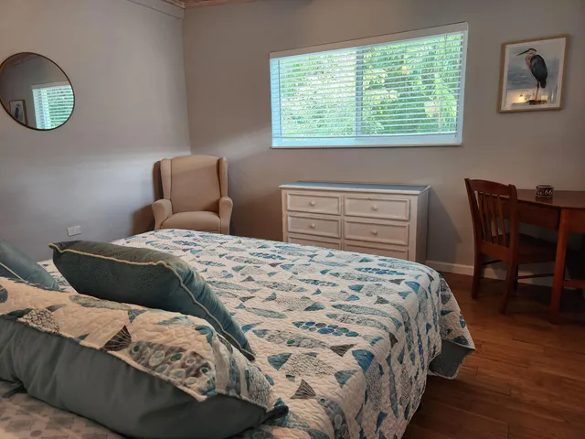 a bedroom with a bed and a table