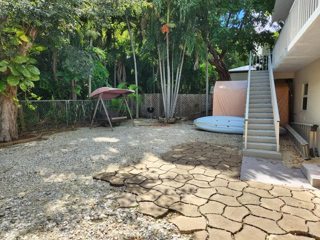 a view of a backyard with chairs