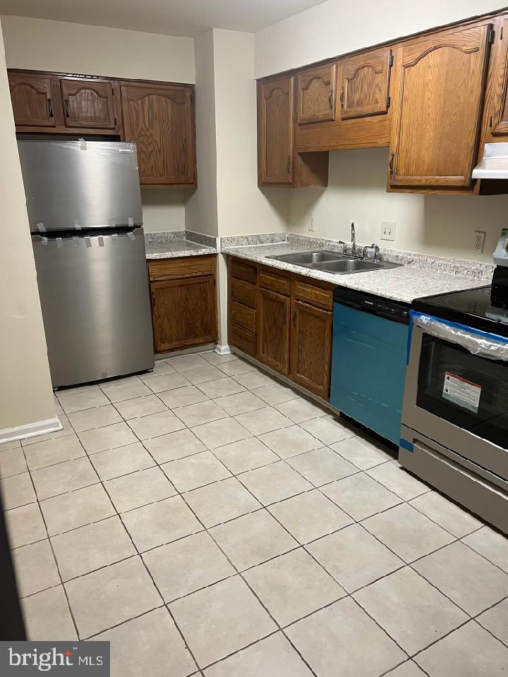 a kitchen with stainless steel appliances a refrigerator sink and cabinets