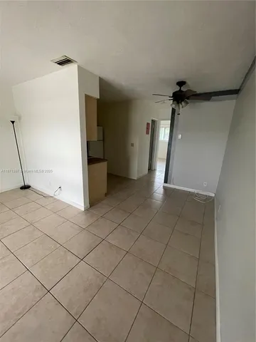 a view of a livingroom with an empty space and a window
