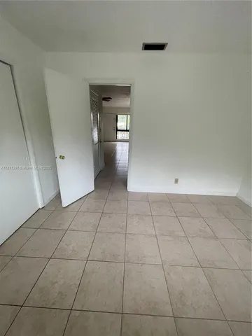 a view of a livingroom with an empty space and a window