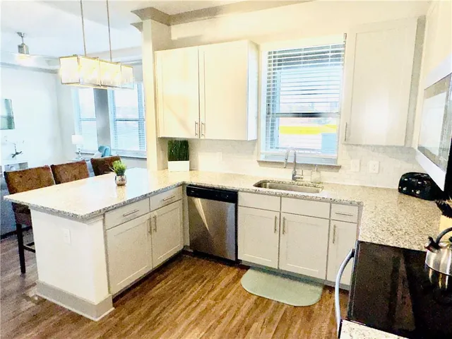 a kitchen with a sink stove and cabinets