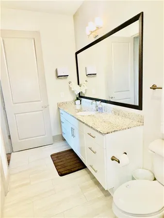 a bathroom with a bathtub sink and a mirror