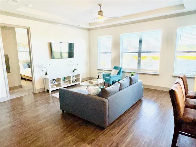 a living room with furniture and a large window