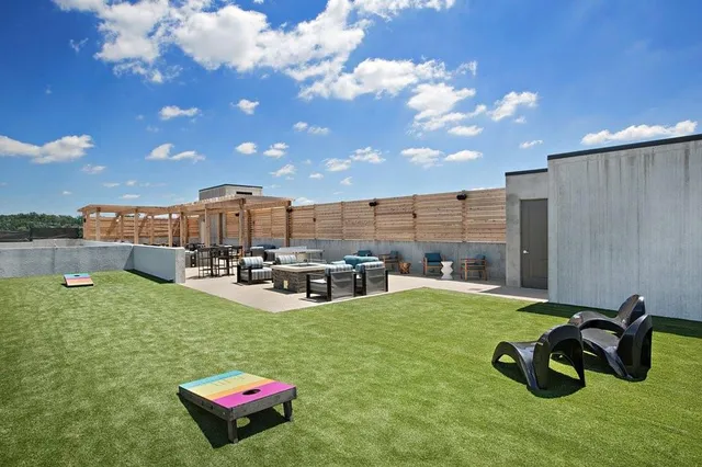 a view of a terrace with lawn chairs