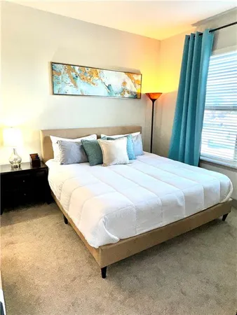 a bedroom with a bed and a night stand