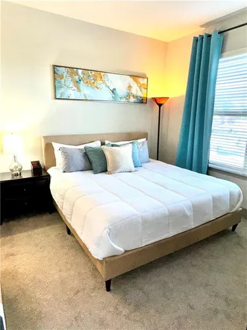 a bedroom with a bed and a night stand