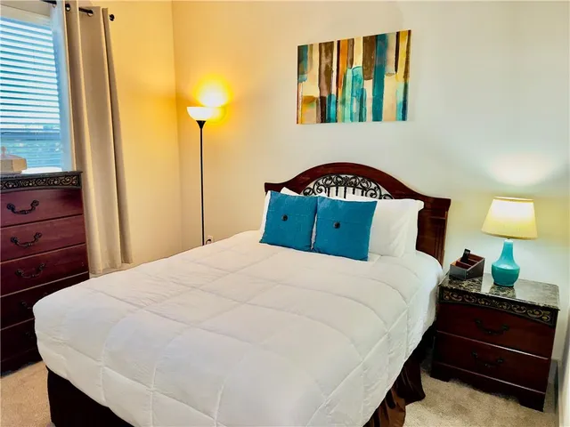 a bedroom with a bed and a night stand