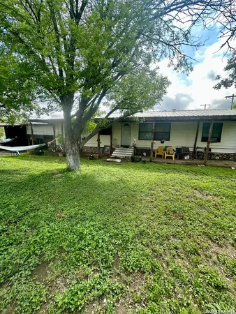 a view of a house with a yard porch and sitting area