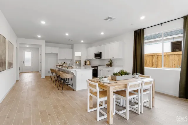 a view of a dining room with furniture and window