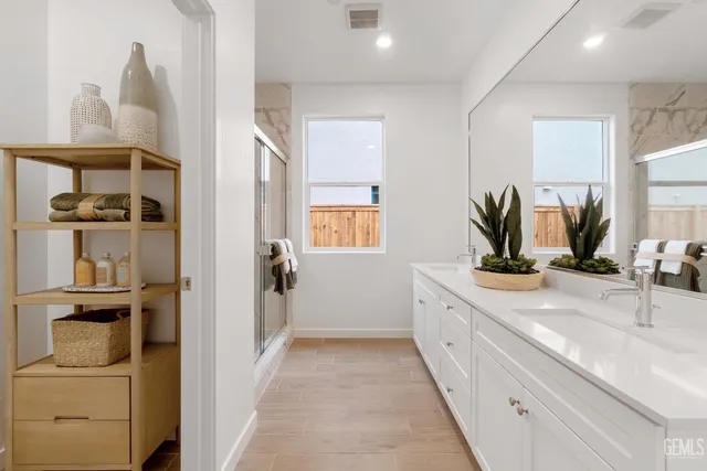 a bathroom with a double vanity sink and a mirror