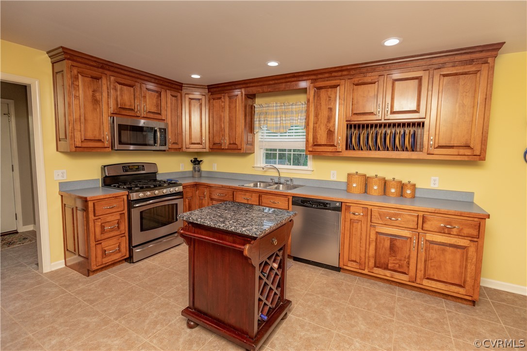 1286 Fletcher Chapel Road Kenbridge, VA 23944 - Photo 16 of 48 a kitchen with granite countertop a stove top oven a sink dishwasher and a microwave oven with cabinets