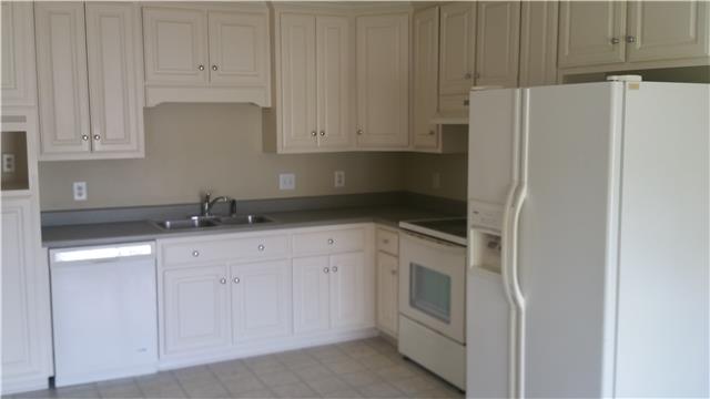 183 Abbey Road Gallatin, TN 37066 - Photo 3 of 4 a kitchen with white cabinets and white appliances