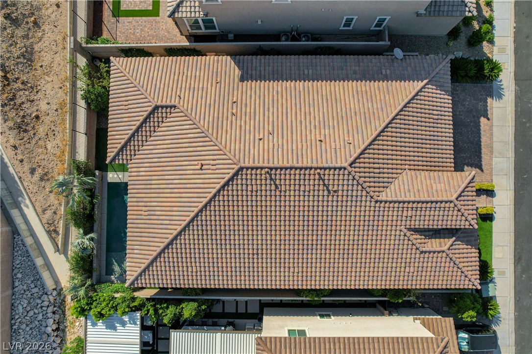3943 Reyes Avenue Las Vegas, NV 89141 - Photo 70 of 95 An aerial perspective showcases the tiled roof of this residence, featuring a private pool and manicured landscaping.