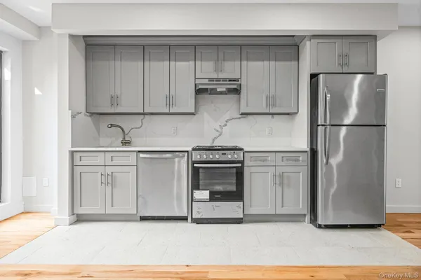 a kitchen with stainless steel appliances a refrigerator sink and cabinets