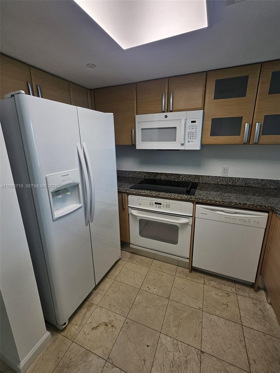2101 Brickell Avenue, Unit 2111 Miami, FL 33129 - Photo 3 of 16 a stove top oven sitting inside of a kitchen